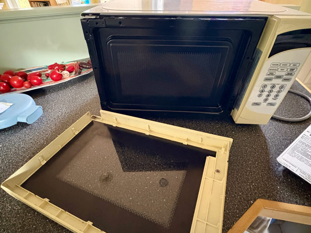 A microwave oven sitting on a kitchen island.